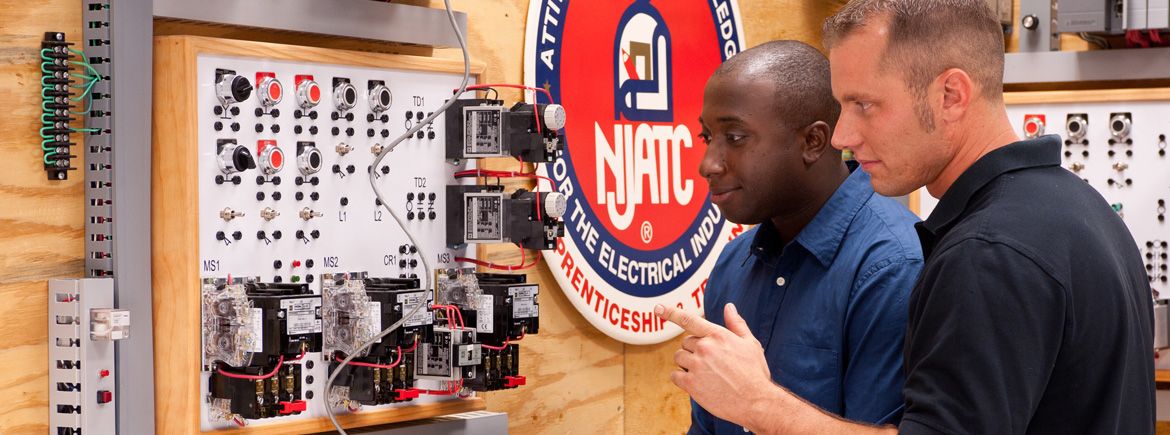 Two men working on electrical project